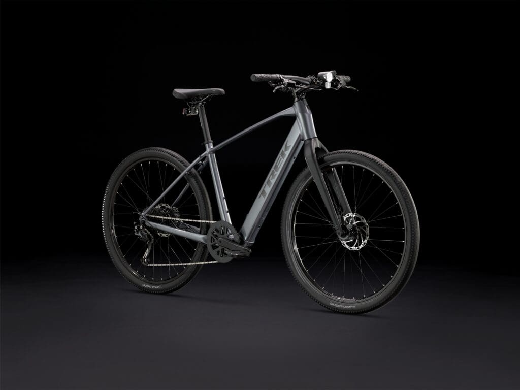 A black bicycle is parked in the dark.